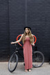 © verity jane smith/Blend Images - Asian woman standing with bicycle
