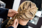 Closeup Of Hairstylist's Hands Braiding Client's Hair