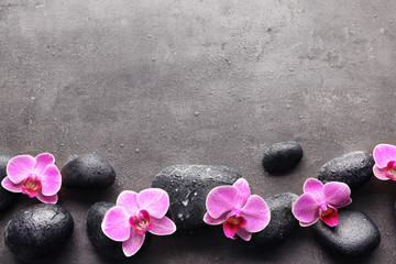 Poster - Spa stones and orchids on dark background