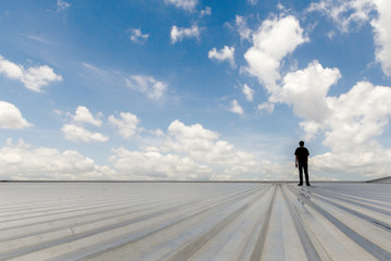 metal sheet roofing on commercial construction with blue sky