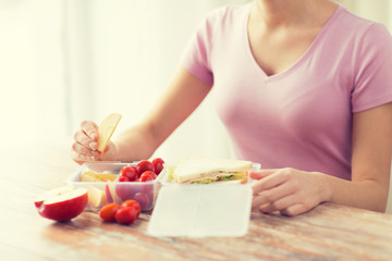 Wall Mural - close up of woman with food in plastic container