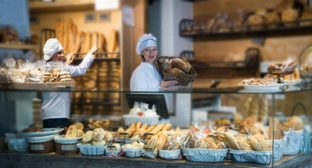 Wall Mural -  women selling fresh pastry and loaves