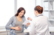 © Syda Productions - gynecologist doctor and pregnant woman at hospital