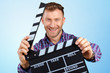 © fotofabrika - Casual man holding an open movie clap