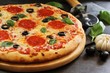 © vm2002 - Homemade Pizza with basil black olives and peperoni, close up, selective focus