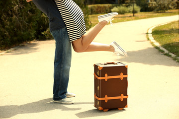 Wall Mural - Young couple with vintage suitcase outdoors