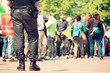 © danylamote - Armed police officer standing guard at a protest mars in a city