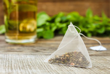 Tea Bag On Background Of Mint And And Cup Of Tea