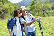 © goodluz - Senior couple on a hiking day looking at map