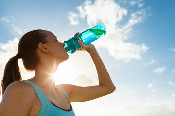 Woman drinking bottle of water.

