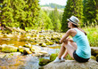 © kieferpix - Active lifestyle. young girl relaxing next to a mountain stream enjoying nature.