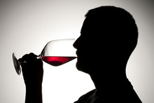 Silhouette Of A Man Sipping Wine