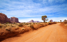Red Dirt Road In Rocky Desert Scenery