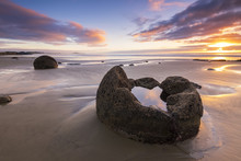 NEW ZEALAND, 22TH APRIL 2015: Moeraki Boulders On The Koekohe Beach, Eastern Coast Of New Zealand. Sunrise And Long Exposure