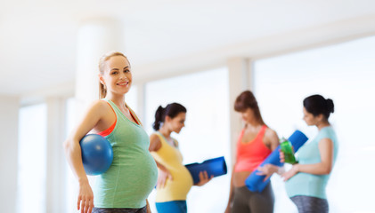 Canvas Print - happy pregnant woman with ball in gym