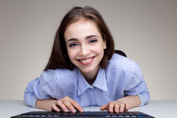 Wall Mural - Attractive smiling female using keyboard