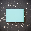 © goodmoments - rectangular light blue box on black background with silver stars decorations. Holiday greetings. Engagement. turquoise on black board.