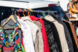 rack of female second hand clothes for donation or charity