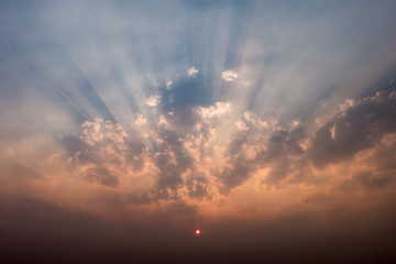 Sunset with clouds and light rays