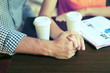 © Africa Studio - Couple drink coffee in cafe outdoors close-up