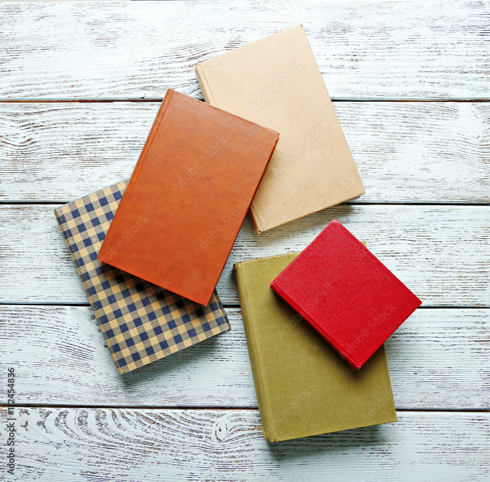 Pile of books on wooden background