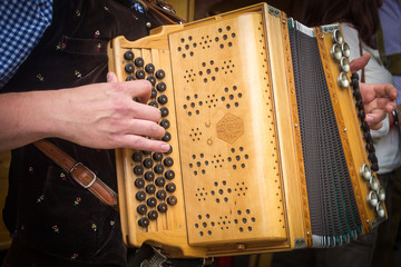 Traditional Bavarian accordion player playing folk music in Austria