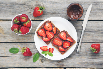 Poster - French toasts with chocolate and strawberry on wooden table