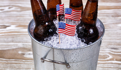 Wall Mural - Holiday USA flags and bucket of ice cold beer on rustic wood