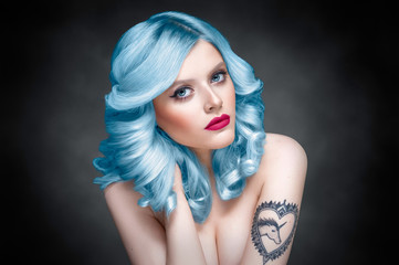 Studio beauty portrait of a girl with blue hair