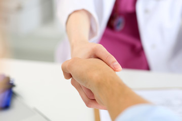 Wall Mural - Female medicine doctor shake hand as hello with male patient