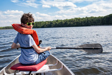Tween boy in rowboat