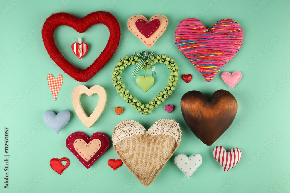 Valentine's Day concept. Handmade hearts on turquoise background, close up