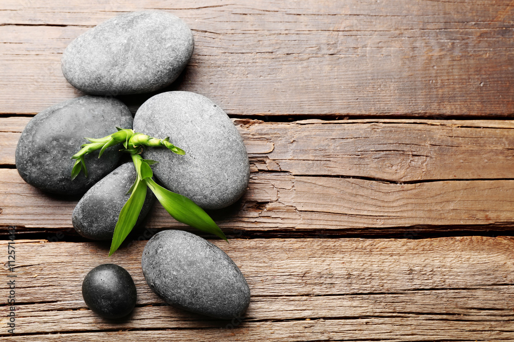 Heap of spa hot stones  on wooden table