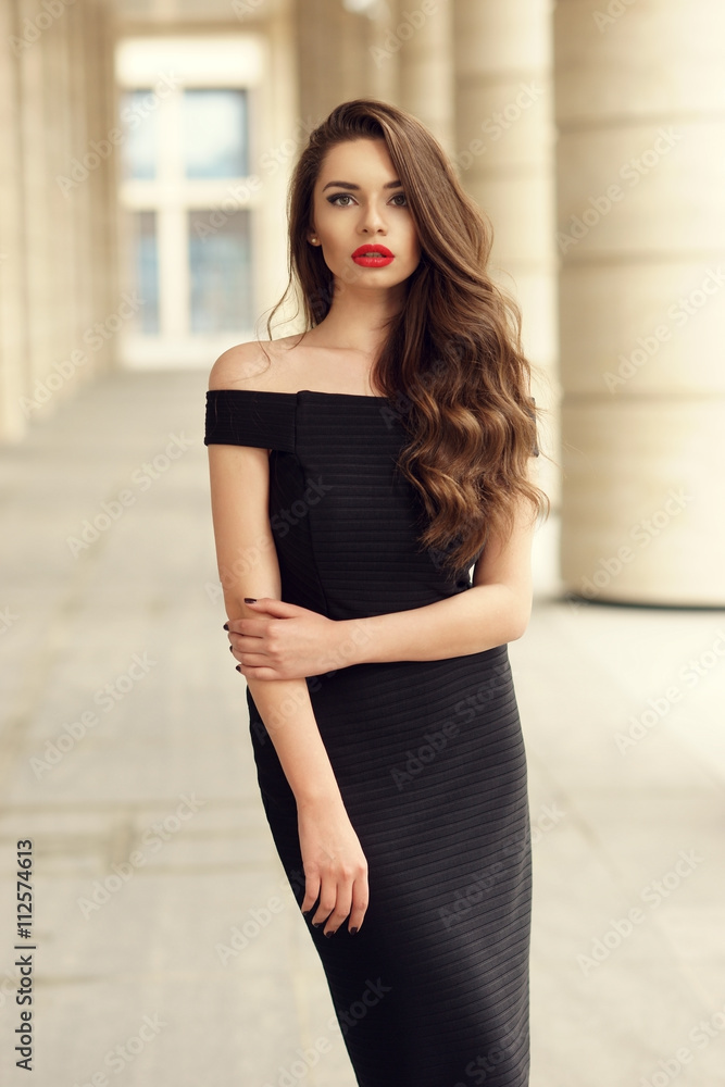 Young elegant girl posing at city street. Pretty beautiful 