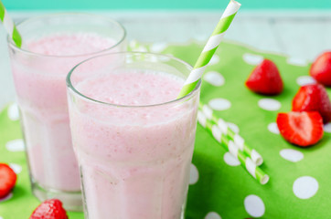 Wall Mural - 
Summer refreshing cold drink , a milkshake with strawberries on a bright color background