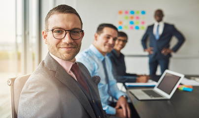 Wall Mural - Handsome man with three co-workers in meeting