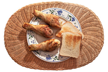 Top of view of dish with chicken and bread. Delicious dish  with chicken and bread on white background
