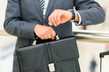 Wall Mural - Businessman looking at his wrist watch