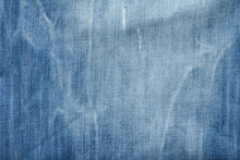 Closed Up Of Blue Creased Denim Jeans Texture
