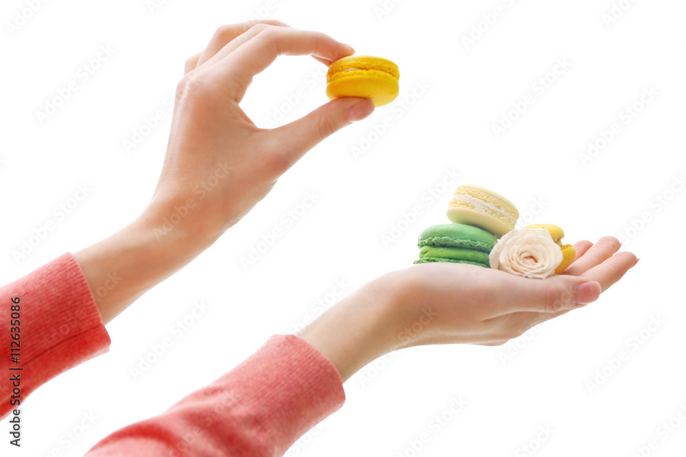 Female hands holding macaroons isolated on white