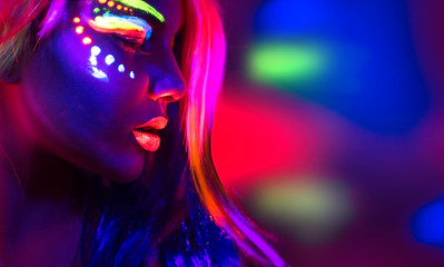 Wall Mural - Fashion model woman in neon light, portrait of beautiful model girl with fluorescent make-up