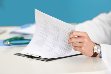 Poster - Doctor working at table in office