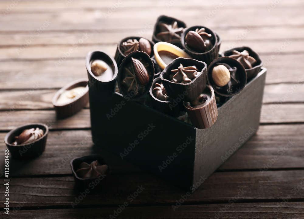 Chocolate sweets on wooden background