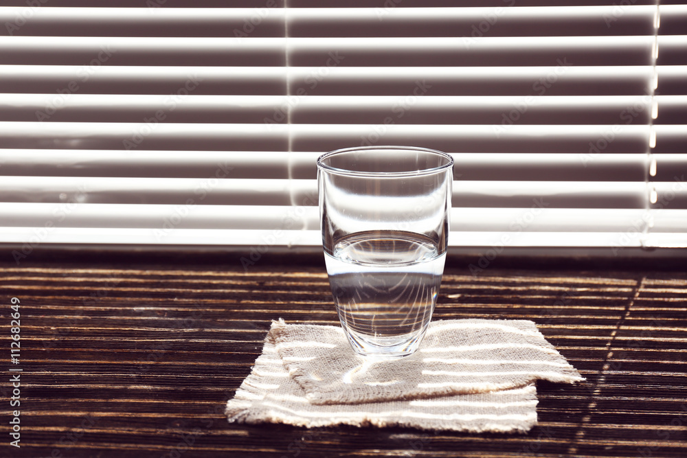 Glass of pure water on the windowsill