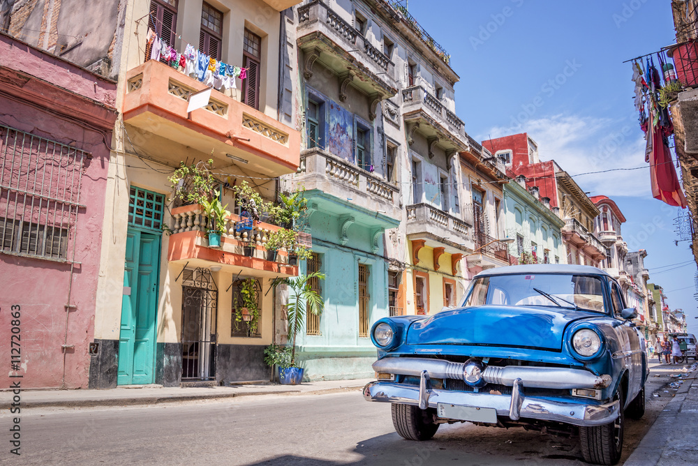 Obraz na płótnie Blue vintage classic american car in a colorful street of Havana, Cuba. Travel and tourism concept. w salonie