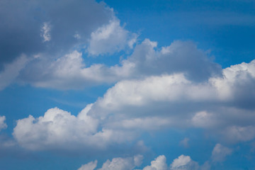 The background bright blue sky with clouds