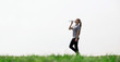 © Northern life - Woman drinking natural water in green field. Concept of health, thirst, hot weather.