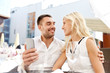 © Syda Productions - couple taking selfie with smatphone at restaurant
