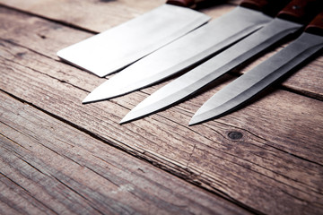 Beautiful knives with wooden handle, on an old table. Kitchen, c