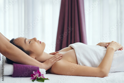 Fotografie, Obraz Side view of Chinese woman relaxing in spa salon